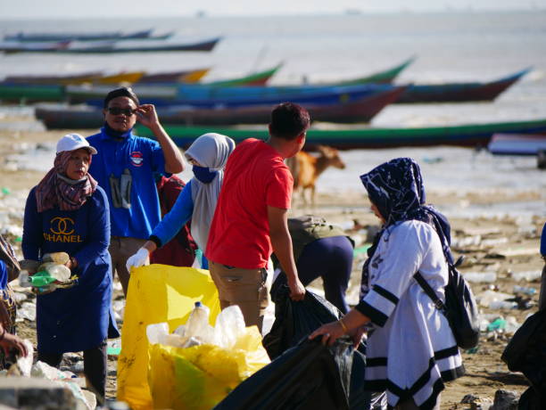 Activity of Indonesian valunteer group keeping plastic waste out from Amal Lama sea beach at Tarakan, Indonesia. Environmental pollution. Conservation, friendship. stock photo