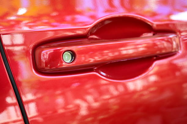 istock door handle of red car, transpotation industry 1435481808