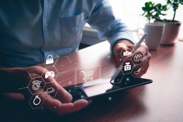 istock Man using portable table touch device with stylus. Online shopping icons and illustrative concept. 1435484439