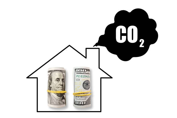 Living house on white background with dollars. CO2 emissions and reducing carbon concept. Clean energy, heat and decarbonization stock photo