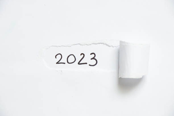 istock 2023 written on white torn paper, happy new year 1435487308