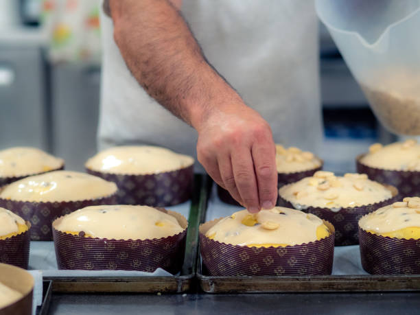 istock artisan italian baker preparing panettone christmas cake adding almonds to icing 1435495293