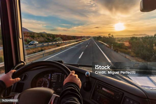 View From The Drivers Seat Of A Truck Of The Highway And A Landscape Of Fields At Dawn With A Dramatic Sky Stock Photo - Download Image Now
