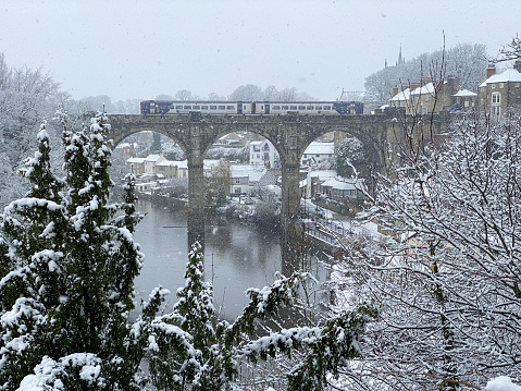 A winter snow view of the railway viaduct over the river Nidd in Knaresborough, North Yorkshire, England, UK