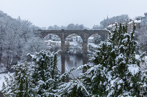 A winter snow view of the railway viaduct over the river Nidd in Knaresborough, North Yorkshire, England, UK