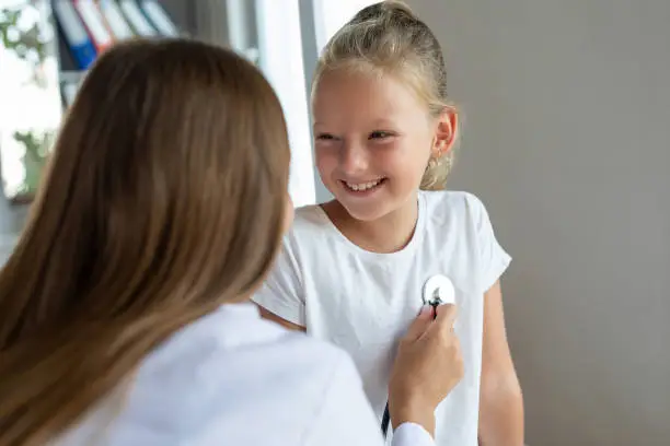 Photo of Female doctor with stethoscope listen to her heartbeat