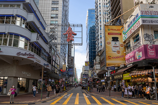 Hong Kong - October 20, 2022 : Pedestrians walk past Sai Yeung Choi Street in Mong Kok, Kowloon, Hong Kong.