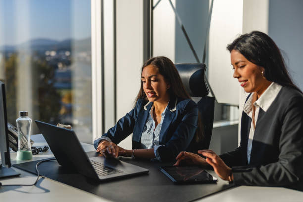 istock Two Hispanic Female Executives Discussing Future Plans and Ideas In The  Head Office 1435504066
