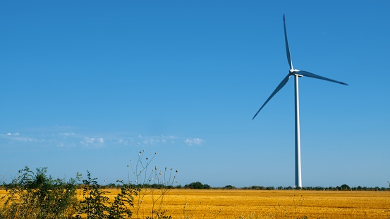 Working wind turbine - the open field landscape