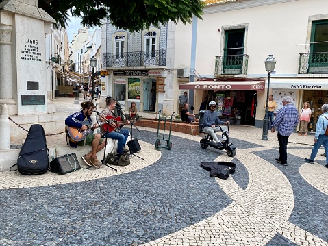 LAGOS,  Portugal - October 20,  2022. People enjoy the performance of street musicians in the city of Lagos.