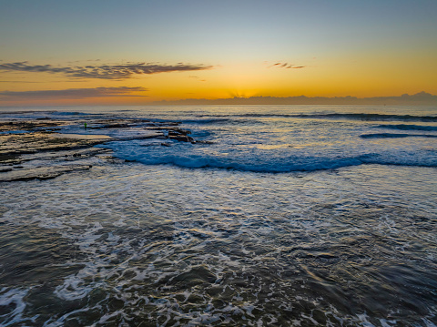 Sunrise over the ocean at Flat Rock beach nxt to the ocean baths in Newcastle, NSW, Australia.