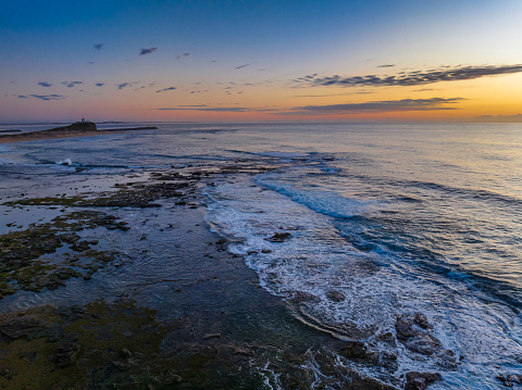 Sunrise over the ocean at Flat Rock beach nxt to the ocean baths in Newcastle, NSW, Australia.
