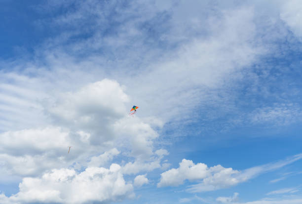 hight up flying kites with beautiful cloudy summer sky on background