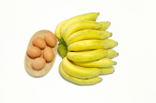 Cavendish Banana with eggs in basket on white background
