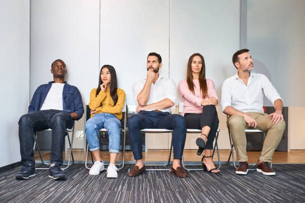 Diverse group of business people waiting for job interview stock photo