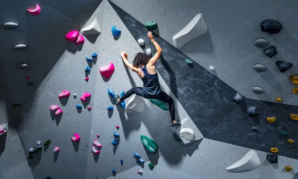 Photo of Sportswoman training climbing on indoor climbing wall
