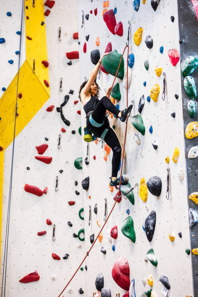 istock Female climber with safety harness climbing on artificial rock wall 1435518206