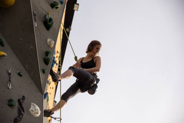 istock Woman rock climber with safety equipment training on the artificial climbing wall 1435518406