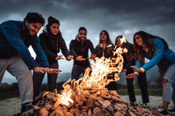 istock friends in front of the campfire all together 1435519644