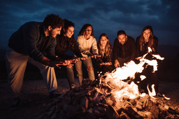 istock friends in front of the campfire all together 1435519755