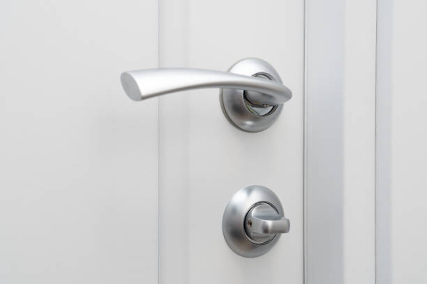 istock Door handle with lock on white wooden Interior door. Privacy concept. 1435520472