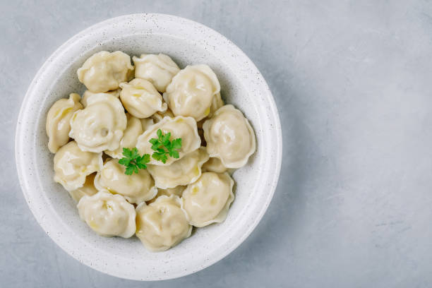 istock Dumplings. Meat stuffed Dumplings in a bowl on gray stone background. 1435522475