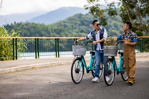 Asian Chinese gay couples on Sun Moon lake bike trail, Travel lifestyle concept