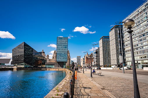 Liverpool skyline from the Strand Street St in England UK United Kingdom, and the water reflection on the Canning Dock in a sunny summer blue sky day.