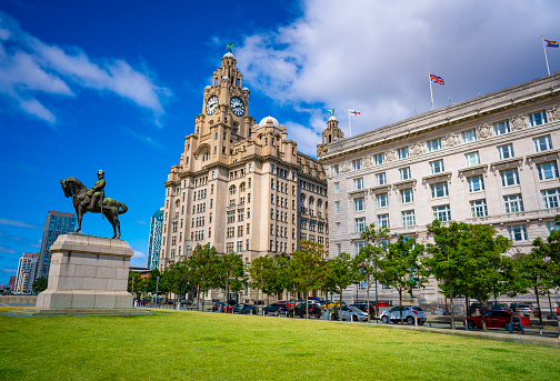Liverpool Pier head Edward Vll Statue with Royal Liver building and Cunard buildingin England UK United Kingdom