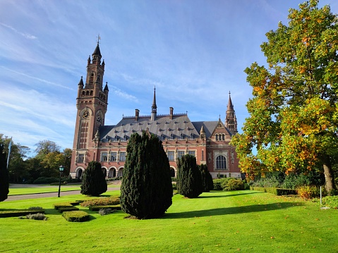 The Hague, Netherlands - October 2022: Scenic view of the Peace Palace (Dutch: Vredespaleis) in the city city of The Hague, Holland on a sunny day. It is an administrative building under international law where various legal organisations are housed.