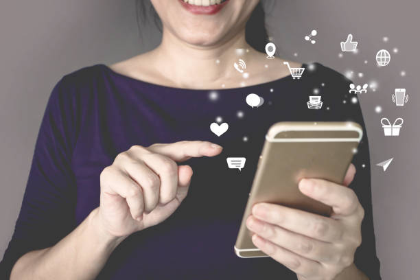 istock Woman is press touch screen on smartphone with modern technology digital icon. Shopping online. Social networking. 1435522832