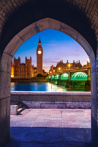 London sunset Big Ben and river Thames at Westminster bridge from arch in England UK Great Britain