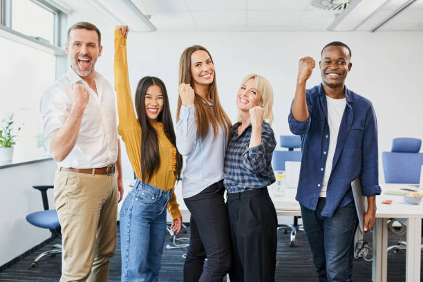 Win success concept group of diverse people celebrating startup business achievement together stock photo