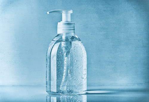 Close up of transparent hand sanitizer - on blue background