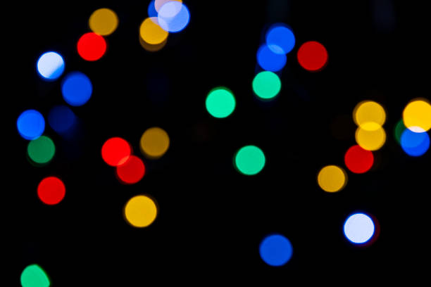 istock Clorful blurred lighs bokeh on black background as a festive backdrop 1435534591