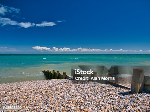 istock A wooden breakwater on the shingle beach in Kingsdown in Kent. Taken on a clear, sunny day with a blue sky, light cloud and a turquoise sea. 1435535309