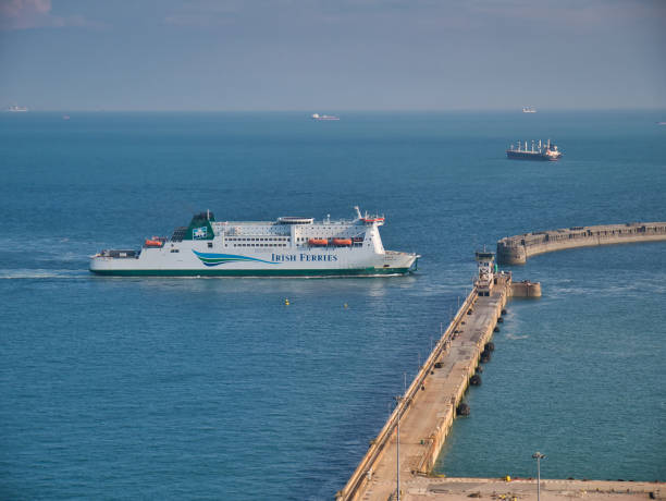 An Irish Ferries cross channel ferry approaches the entrance to the Port of Dover. Taken on a calm day with flat seas in summer. An Irish Ferries cross channel ferry approaches the entrance to the Port of Dover. Taken on a calm day with flat seas in summer. ferry dover england calais france uk stock pictures, royalty-free photos & images