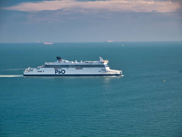 A white P&O cross channel ferry approaches the Port of Dover. Taken on a calm day with flat seas in summer. A white P&O cross channel ferry approaches the Port of Dover. Taken on a calm day with flat seas in summer. ferry dover england calais france uk stock pictures, royalty-free photos & images