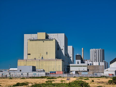 The non-operational nuclear power stations Dungeness A (Magnox - left) and Dungeness B (AGR - right) on the Dungeness headland in Kent, UK. Taken on a sunny day in summer.