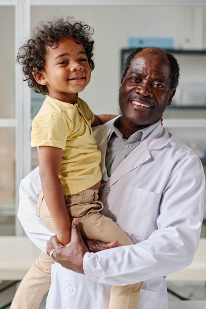 istock Male pediatrician with little patient 1435539990