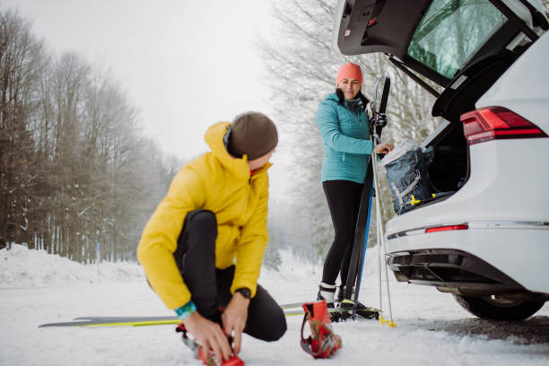 istock Senior couple near car trunk preparing for winter skiing. 1435542811