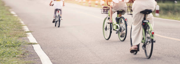 istock Happy family is riding bikes outdoors. Banner background. 1435548274