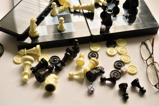 istock Chess pieces, phone, glasses and board on the table. 1435556072