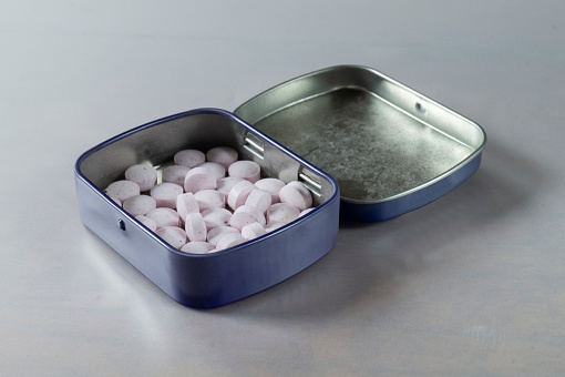 Sweet candies in a metal box. Refreshing pills close-up.Mint lollipop for fresh breath
