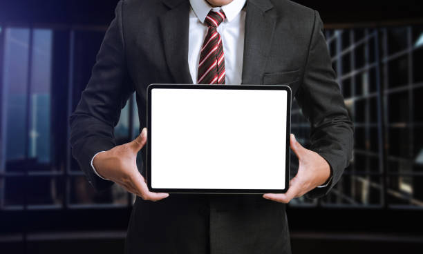 istock Business man holding and shows touch screen tablet with digital device, technology 1435558419