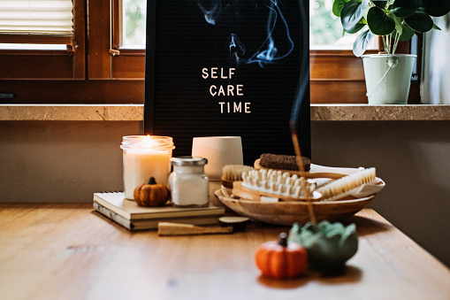Self-care, Wellness in autumn, winter cold season. Letter board text Self Care Time, aroma sticks, body and self-care handmade cosmetics and beauty product and decor pumpkins