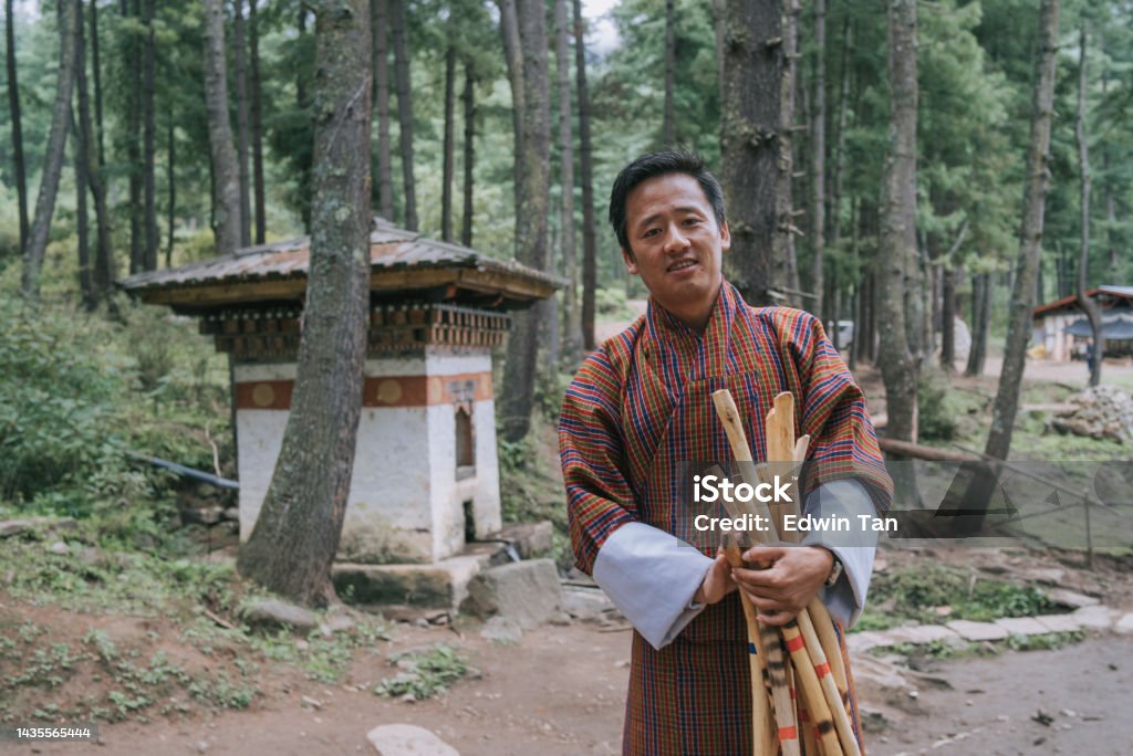 Bhutanese male tour guide holding hiking pole looking at camera smiling  prepare hiking up to Taktsang Monastery , Tiger Nest in Bhutan Taktsang Monastery Stock Photo