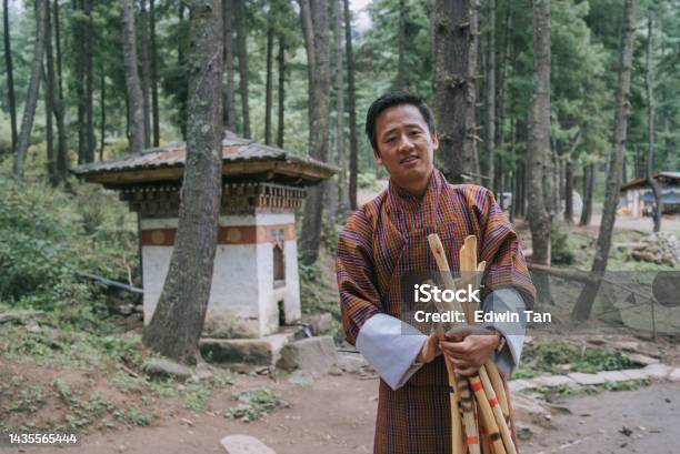 Bhutanese Male Tour Guide Holding Hiking Pole Looking At Camera Smiling Prepare Hiking Up To Taktsang Monastery Tiger Nest In Bhutan Stock Photo - Download Image Now