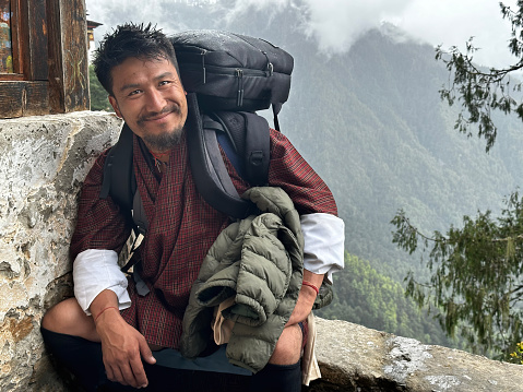 Bhutanese Tour Guide Sitting Resting hiking to Paro Taktsang  Monastery in Bhutan
