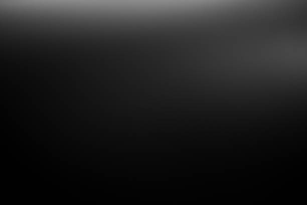 istock Dark black and gray blurred  gradient background has a little abstract light. 1435571375